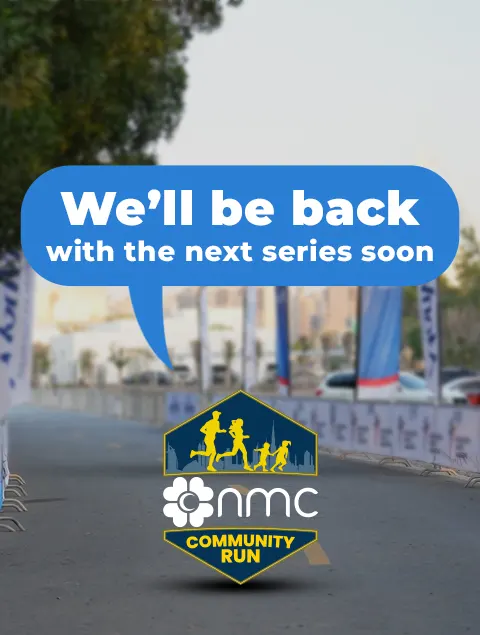 Banner announcing the return of the NMC Community Run, featuring a blue speech balloon and logo on a blurred street background.