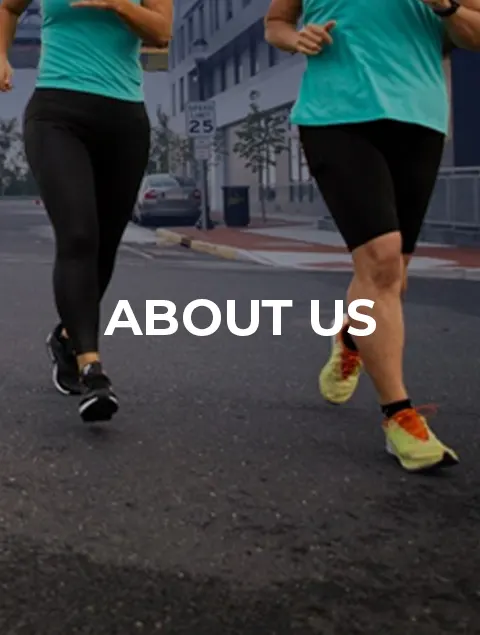 Two people jogging on a city street wearing athletic gear, with ABOUT US text overlayed in the center.